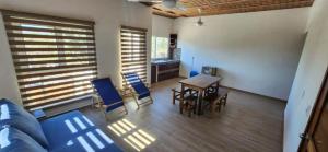 a living room with a couch and a table and chairs at Meztli Beach House in La Manzanilla