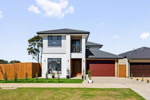a white house with a fence at Spacious Private 4BR Upper Floor Sleeps 8 Spa Free parking in Werribee