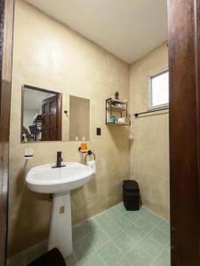 a bathroom with a sink and a mirror at Casa Bugambilia Progreso #4 in Progreso