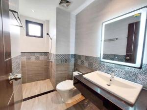 a bathroom with a sink and a toilet and a mirror at Lunaria Maison - HCM Center Stay in Ho Chi Minh City +43 photos