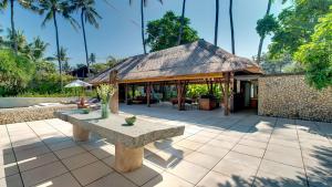 a pavilion with a bench in front of a building at Villa Samadhana in Ketewel