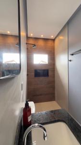a bathroom with a sink and a fire extinguisher at Hotel e Restaurante Santa Isabel in São Raimundo Nonato +46 photos