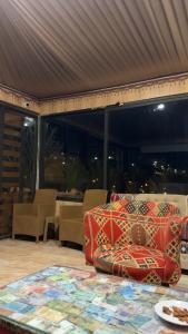 a room with chairs and a couch on a table at Jihad camp in Disah +2 photos