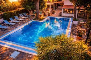 an overhead view of a swimming pool in a resort at Oasis Apartments & Rooms in Plakias