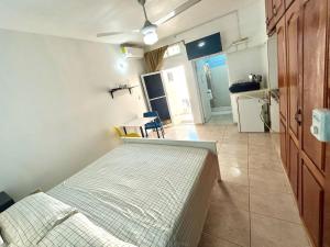 a small bedroom with a bed and a kitchen at PC 5 a 50 mts de la playa in Río San Juan