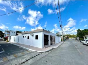 a white building on the side of a street at PC 5 a 50 mts de la playa in Río San Juan