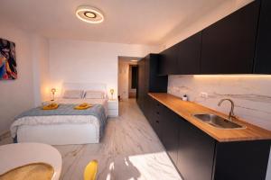 a small bedroom with a bed and a sink at Romantic Sea View Studio with Jacuzzi in Alicante Center in Alicante