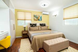 a bedroom with a bed and a yellow wall at Paradise Haven Saint Lucia in Corinthe +21 photos
