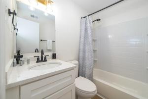 a bathroom with a sink and a toilet and a tub at Sojourn's Harborage 2 BR 1 BA in Norfolk