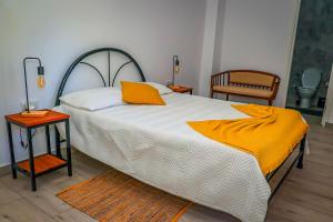a bedroom with a large bed with an orange blanket at Kasa Wahnon in Pombas +70 photos