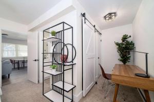 a room with a table and a shelf with plants at Sojourn's Harborage Pet-Friendly # 3 in Norfolk