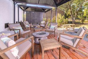 a deck with a bunch of chairs and tables at Sojourn's Harborage Pet-Friendly # 3 in Norfolk