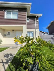 a house with a plant in front of it at Acogedora casa cerca del mar in San Pedro de la Paz