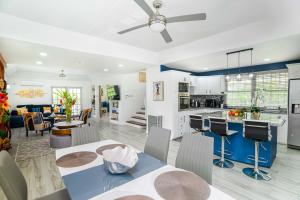 a kitchen and living room with a table and chairs at Paradise Haven Saint Lucia in Corinthe