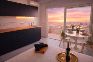 a kitchen with a table with a bottle of wine at Romantic Sea View Studio with Jacuzzi in Alicante Center in Alicante