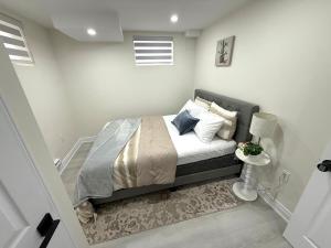 a bedroom with a bed in a white room at Modern 2BR Suite Private Entrance Parking New in Woodstock