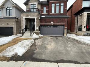 a driveway in front of a house with a garage at Modern 2BR Suite Private Entrance Parking New in Woodstock