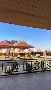 a patio with benches and tables and umbrellas at Star night in Disah