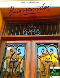 a front door of a building with stained glass windows at Hotel PREMIER in Linares