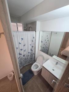a small bathroom with a toilet and a sink at Sueños de Serena del Mar in Cartagena de Indias