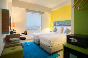 a hotel room with a bed and a window at KHAS Surabaya Hotel in Surabaya +24 photos