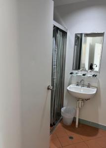 a bathroom with a sink and a mirror at Amaroo Hotel Dubbo in Dubbo