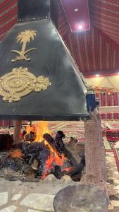 a large pot over a fire in a room at Sunset mountain in Disah