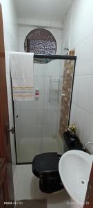 a bathroom with a shower and a toilet and a sink at Villa sonhos in Belém +9 photos