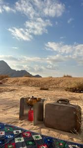 a group of suitcases sitting on the ground in the desert at Moon view in Disah