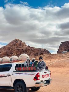 a group of people sitting in the back of a truck at Moon view in Disah
