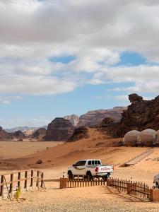 a white truck parked in the middle of the desert at Moon view in Disah