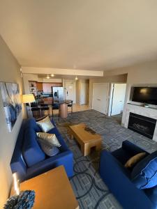 a living room with blue couches and a fireplace at Idyllic Suite - Las Vegas in Las Vegas