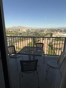 a table and chairs on a balcony with a view at Idyllic Suite - Las Vegas in Las Vegas