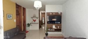 a living room with a couch and a chandelier at Villa sonhos in Belém