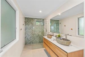 a bathroom with a sink and a shower at Surf Gums, Sleeps 9, Pet Friendly, Fully Renovated in Point Lookout +18 photos
