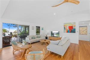 a living room with couches and chairs and a table at Surf Gums, Sleeps 9, Pet Friendly, Fully Renovated in Point Lookout