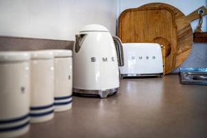 a group of toasters sitting on top of a counter at The Shack - Beachside At Binalong in Binalong Bay