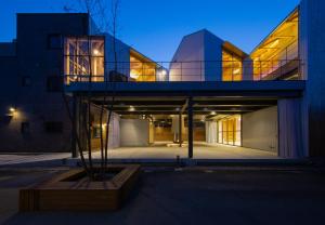a house with a glass facade at night at Inn Azur in Yamatotakada