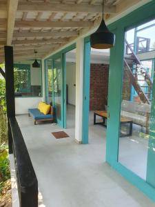 a patio with a blue couch and a table at casa luna villa in Narigama