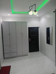 a room with white cabinets and a black door at Olori apartments in Adeleye