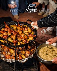 a bunch of food is cooking on a grill at Bedouin Nights Camp in Wadi Rum