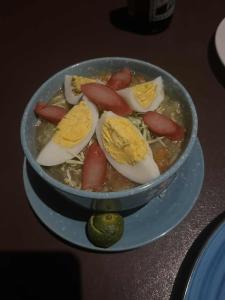 a bowl of food with eggs on a table at DANG dang Balbago Beach in El Nido +84 photos