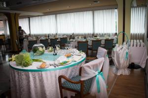a banquet hall with a table with plates of food at Hotel San Nicola in Lagonegro