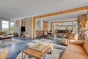 a living room filled with furniture and a stone wall at Duinvilla Noordwijk in Noordwijk
