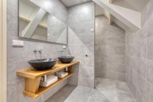 a bathroom with two sinks and a shower at Duinvilla Noordwijk in Noordwijk +28 photos