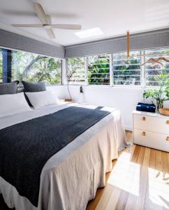 a bedroom with a large bed and windows at Crane Lodge in Palm Beach +38 photos
