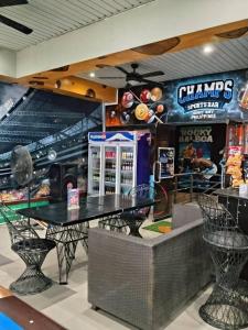 a dining room with a table and a game room at Baywatch Beach Resort in Olongapo
