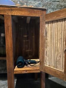 a wooden cabinet with a telephone on top of it at Chez Lepusa in Sidemen