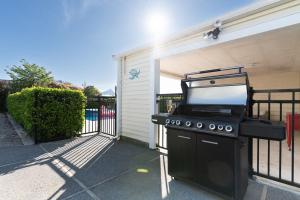 a barbecue grill in front of a house at Sunset Villa in Martinborough