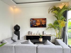 a living room with a couch and a table at Umah Sepur Villa in Dalung